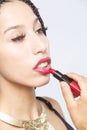 Portrait of beautiful young Latina woman applying red lipstick Royalty Free Stock Photo