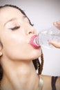 Portrait of beautiful young Latina woman taking a swig Royalty Free Stock Photo