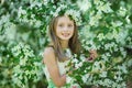 Portrait of a beautiful young long-haired girl. Adorable child having fun in blossom cherry garden on beautiful spring day Royalty Free Stock Photo