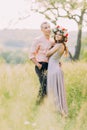 Portrait beautiful young loving couple hugging in blooming spring garden Royalty Free Stock Photo