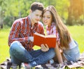 Portrait beautiful young man and girl reading a book Royalty Free Stock Photo