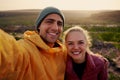 Portrait of beautiful young man and woman hugging and smiling after hiking looking at camera