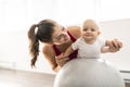 A Portrait of beautiful young mother in sports wear with her charming little baby in training session Royalty Free Stock Photo