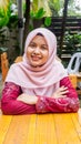 A portrait of beautiful young Muslim Malay woman wearing a hijab and modern traditional dress called