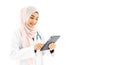 Portrait of beautiful young Muslim woman doctor using digital tablet computer, standing isolated on white background Royalty Free Stock Photo