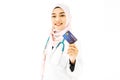 Muslim woman doctor wearing a stethoscope standing holding credit card with happy and smiling isolate on white background. Royalty Free Stock Photo