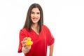 Portrait of beautiful young nurse wearing scrubs showing toy duck Royalty Free Stock Photo