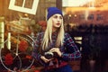 Portrait of beautiful young playful hipster woman with old retro camera. Model looking aside. City lifestyle. Toned Royalty Free Stock Photo