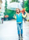 Portrait of beautiful young pre-teen girl with umbrella under rain Royalty Free Stock Photo