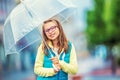 Portrait of beautiful young pre-teen girl with umbrella under rain Royalty Free Stock Photo