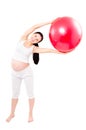 Portrait of a beautiful young pregnant woman executing exercises with fitball Royalty Free Stock Photo