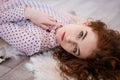Portrait of a beautiful red-haired woman lying on the floor Royalty Free Stock Photo