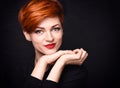 Portrait of a beautiful young red-haired woman with short hair on a dark background Royalty Free Stock Photo