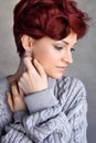 Portrait of a beautiful young red-haired woman with short hair wearing warm woolen sweater Royalty Free Stock Photo