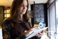 Beautiful young saleswoman using her digital tablet in organic shop.