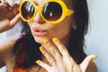 Portrait of a beautiful young brunette girl with expressive eyes and full lips, and sunglasses posing for the camera Royalty Free Stock Photo