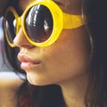 Portrait of a beautiful young brunette girl with expressive eyes and full lips, and sunglasses posing for the camera Royalty Free Stock Photo