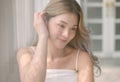 Portrait of Beautiful young sexy Korean or Japanese girl with natural make-up wearing tank top, smiling coquettish, touching her Royalty Free Stock Photo