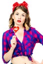 Portrait of beautiful young woman with vintage make-up and hairstyle with lollipop Royalty Free Stock Photo