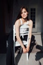 Portrait of a beautiful young slender woman sitting on a chair Royalty Free Stock Photo