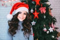 Portrait of a beautiful young smiling girl in a Santa hat. Royalty Free Stock Photo
