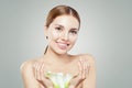 Portrait of beautiful young smiling woman with clear healthy skin and white flowers in her hands Royalty Free Stock Photo