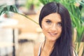 Portrait of beautiful young smiling woman with long black hair outdoors Royalty Free Stock Photo