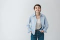 Portrait of beautiful young student girl with short dark hair in stylish casual clothes laughing with university friends Royalty Free Stock Photo