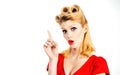 Portrait of beautiful young surprised woman, dressed in red pin-up dress. Caucasian blond model posing in retro fashion Royalty Free Stock Photo