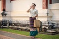 A beautiful young Thai-Asian woman in a traditional Thai-Northern dress is in a beautiful temple Royalty Free Stock Photo