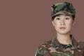 Portrait of beautiful young US Marine Corps soldier over brown background