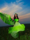 Portrait of a beautiful young woman on background of sunset