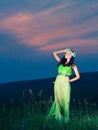 Portrait of a beautiful young woman on background of sunset