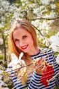 Portrait of beautiful young woman in blooming park on a sunny day. Smiling girl with Magnolia flowers Royalty Free Stock Photo