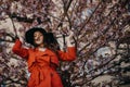 Portrait of beautiful young woman with blooming tree in spring in park. Royalty Free Stock Photo