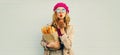 Portrait of beautiful young woman blowing her red lips sending sweet air kiss holding grocery shopping paper bag with long white Royalty Free Stock Photo