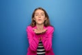 Portrait of beautiful young woman blowing kiss on color background Royalty Free Stock Photo