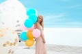 Portrait of beautiful young woman with bunch of balloons Royalty Free Stock Photo