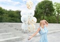 Portrait of beautiful young woman with bunch of balloons Royalty Free Stock Photo