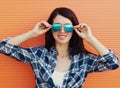 Portrait of beautiful young woman in casual over orange background Royalty Free Stock Photo