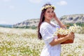 Portrait of a beautiful young woman in chamomile field. Happy girl collecting daisies. A girl resting in a field of chamomile. S Royalty Free Stock Photo