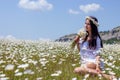 Portrait of a beautiful young woman in chamomile field. Happy girl collecting daisies. A girl resting in a field of chamomile. S Royalty Free Stock Photo