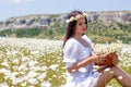 Portrait of a beautiful young woman in chamomile field. Happy girl collecting daisies. A girl resting in a field of chamomile. S Royalty Free Stock Photo