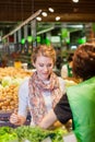 Portrait of beautiful young woman choosing green leafy vegetable Royalty Free Stock Photo