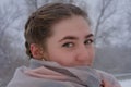 Portrait of  beautiful young woman close-up. Lady with green eyes in winter outdoors snowfall Royalty Free Stock Photo