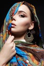 Portrait of beautiful young woman in color veil and jewelry Royalty Free Stock Photo