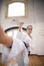 Portrait of beautiful young woman in combative position