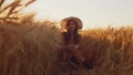 Portrait of beautiful young woman in a countryside field. Female face in the rays of sunset. Freedome and happiness.