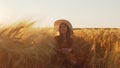 Portrait of beautiful young woman in a countryside field. Female face in the rays of sunset. Freedome and happiness.