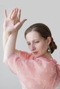 Portrait of a beautiful young woman dancing flamenco in a pink dress on a white background Royalty Free Stock Photo